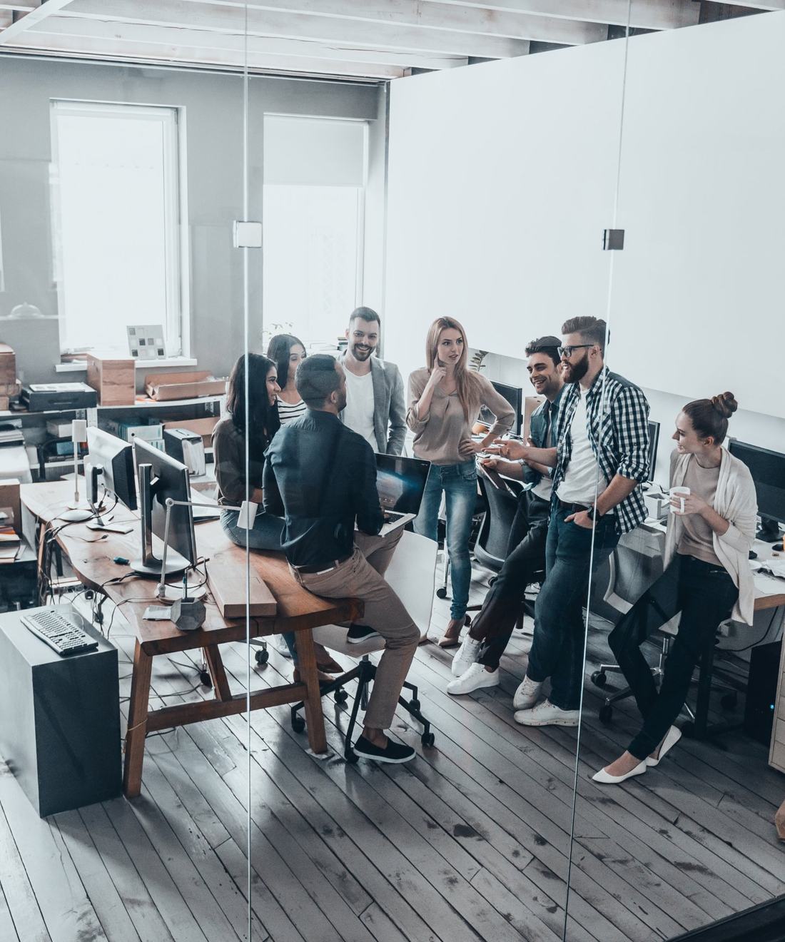 A team talking through a plan together in an open office