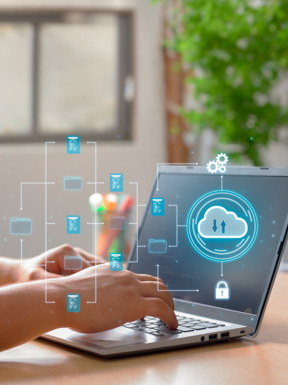 Hands on a laptop with connected files and automation icons