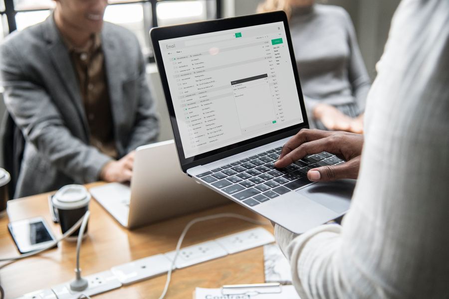 Reviewing email and sales systems on a laptop